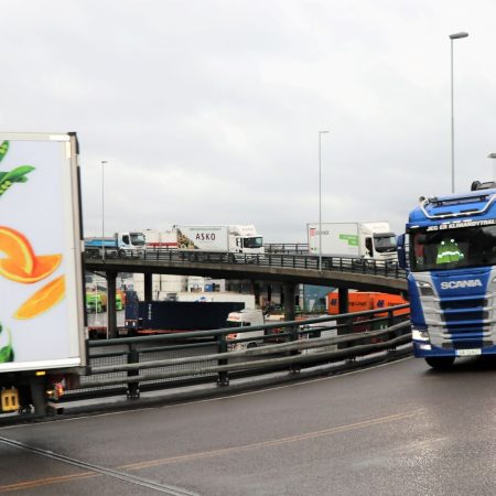 photo of truck driving on a busy street