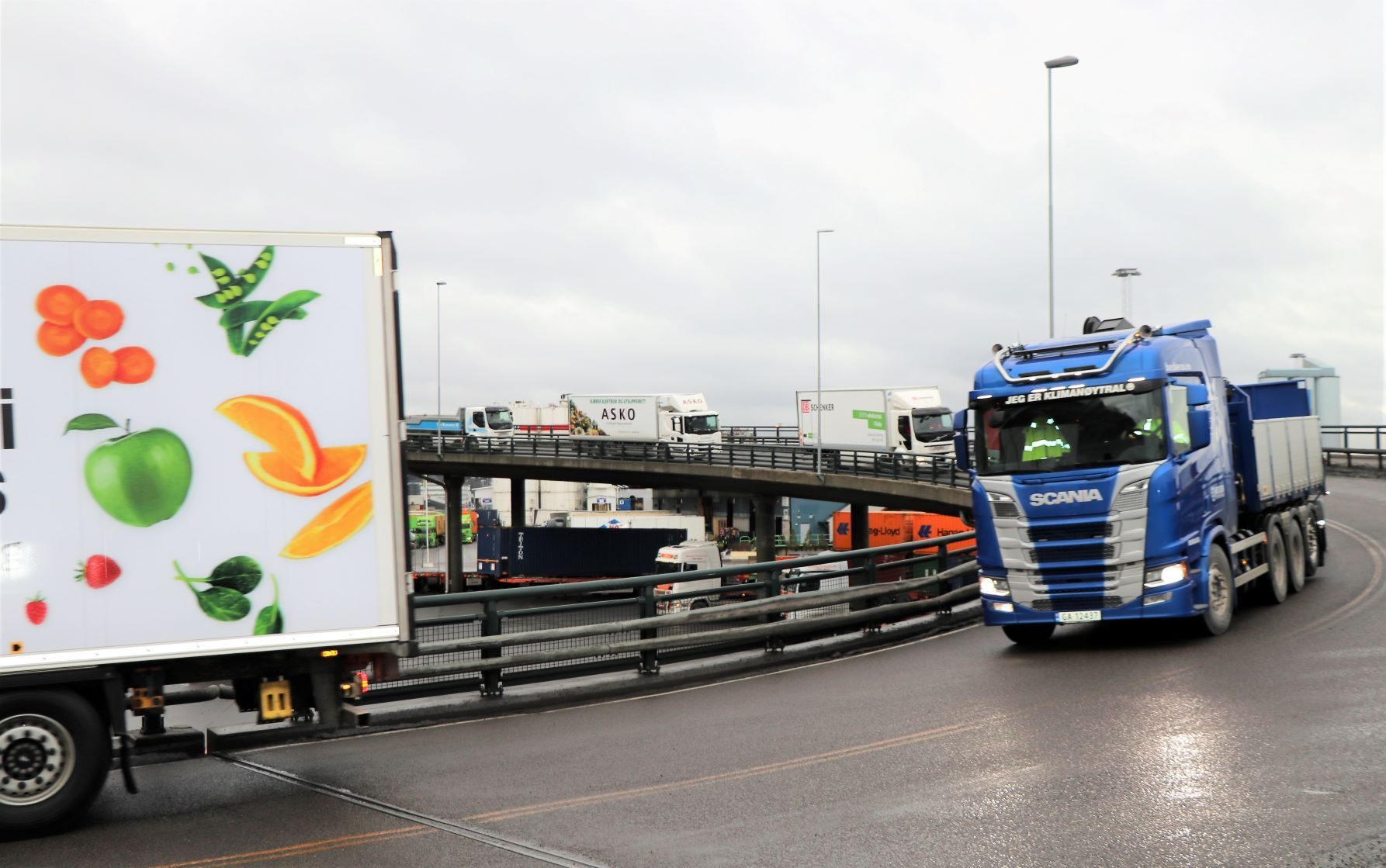 photo of truck driving on a busy street