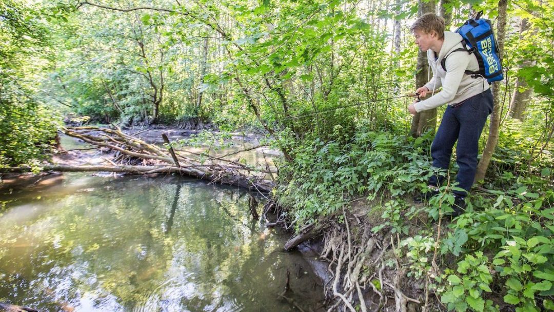 young boy fishing in a river