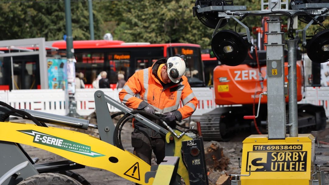 Electric excavators, construction site, busy street