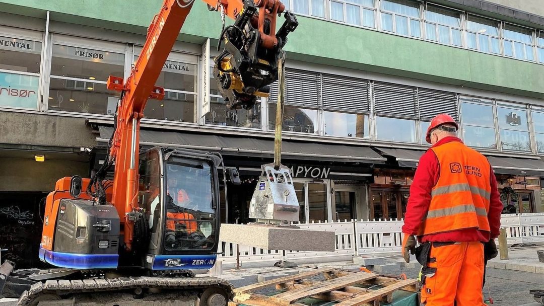 Electric excavator, construction worker