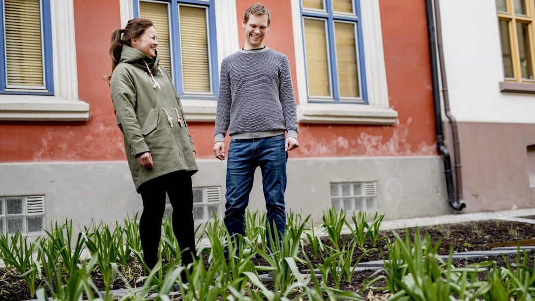 mann og dame foran blomsterbedd som holder på regnvannet