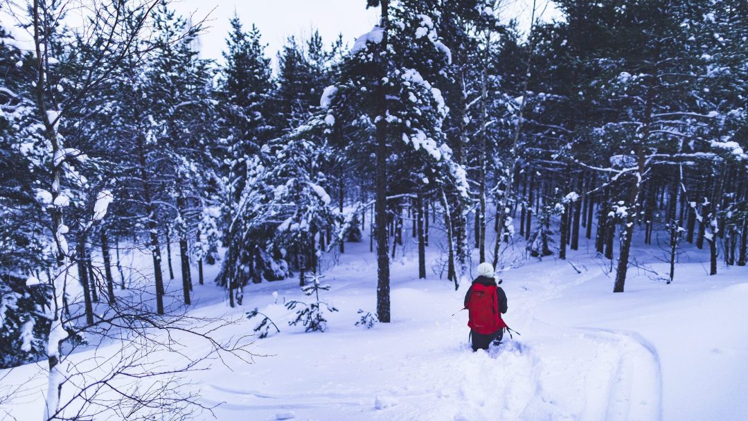 woman going for a hike in the snow outside the beaten track