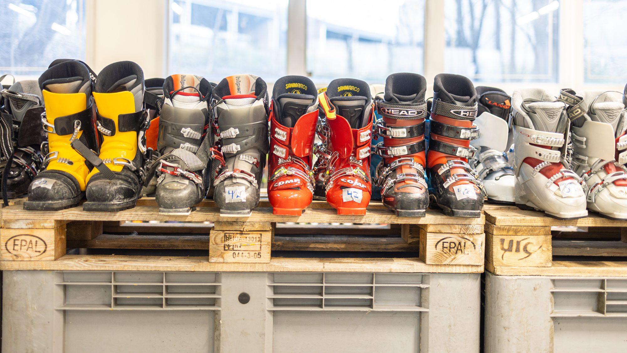 En rekke skisko i ulike farger og merker, merket for ombruk